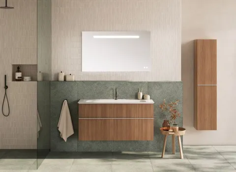 Ein elegantes Badezimmer mit einem Waschtischunterschrank aus der Serie Fiumo 2.0 in warmer Holzoptik.
